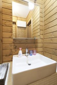 a bathroom with a white sink and a mirror at 旧軽井沢 AZ-BASE Karuizawa in Karuizawa +33 photos
