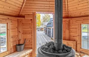 an outside view of a wooden cabin with a wood stove at Nice Home In Arvidsjaur With Sauna in Arvidsjaur
