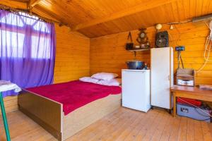 a small room with a bed and a refrigerator at Apartments by the sea Cove Kurila, Losinj - 24571 in Mali Lošinj