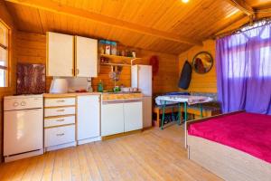 a kitchen with a bed and a table in a room at Apartments by the sea Cove Kurila, Losinj - 24571 in Mali Lošinj