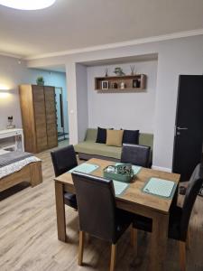 a living room with a table and a couch at Apartman277 Palić in Palić