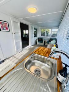 a kitchen with a sink in the middle of a room at Saltwater Studio in Motueka