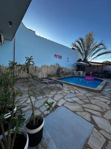 a patio with a swimming pool and some plants at Pousada Love Piri in Pirenópolis