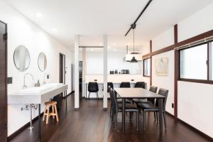 a kitchen and dining room with a table and chairs at J style villa Sapporo フルリフォーム 長期滞在にもオススメ マーケット近く in Sapporo