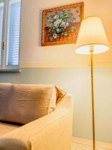 a living room with a couch and a lamp at Casa Maddalena in Casatisma +39 photos