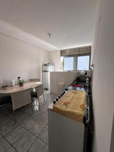 a kitchen with a counter and a table in it at Hospedagem da Mag in João Pessoa