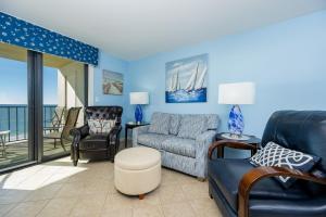 a living room with a couch and a chair at Phoenix I 1078 condo in Orange Beach