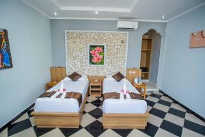 Postel nebo postele na pokoji v ubytování The Tanis Beach Resort Nusa Lembongan