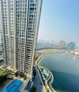 an aerial view of a large building next to a body of water at Hanoi - Vinhomes Skylake - Luxury Services Apartments - GalaxyHouse in Hanoi