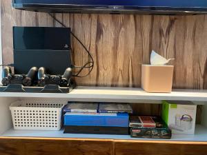 a shelf with a computer and other items on it at MM Cozy Cabin in San Fernando