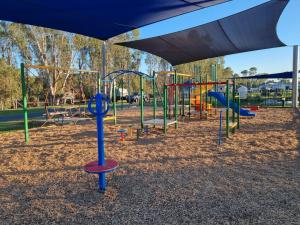 a playground with a row of swings at Bridgewater Caravan Park Near Bendigo in Bridgewater-on-Loddon