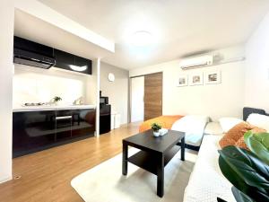 a living room with a couch and a table at ToyoHomes西新宿 in Tokyo +54 photos