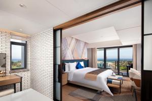 Letto o letti in una camera di Lingshui Xiangshui Bay Summer Surfing Resort