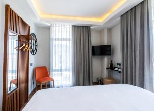 Postel nebo postele na pokoji v ubytování Discovery Hotel