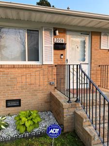a house with a sign in front of it at Bayshore Breeze Hampton-Buckroe Long Term Stay in Hampton
