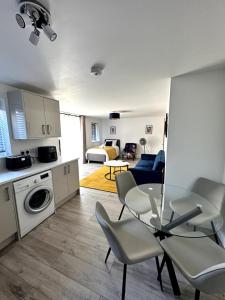 eine Küche und ein Wohnzimmer mit Tisch und Stühlen in der Unterkunft Modern Ground floor 2 Bed Room Apartment Work Leisure Free Parking in Woking