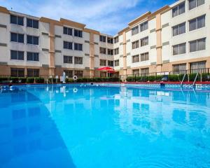 a large swimming pool in front of a building at Ramada by Wyndham Birmingham Airport in Birmingham