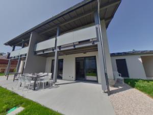 a patio with a table and chairs in front of a building at Villa moderne et spacieuse aux Rousses, proche ski, jusqu'à 12 pers. - FR-1-834-6 in Les Rousses