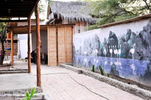 a wall with a painting of animals on it at Bird house in Máncora