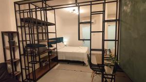 a room with a bunk bed and a room with a ladder at Studio 61- No Coração de Curvelo in Curvelo