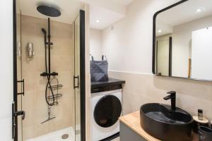 une salle de bain avec un lavabo et une machine à laver dans l'établissement Appartement cosy lumineux avec balcon, à Nice 11 autres photos