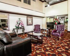 a living room with two leather chairs and a table at Ramada by Wyndham Birmingham Airport in Birmingham
