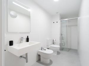 a bathroom with a toilet and a sink and a shower at Apartment in Las Palmas near Playa Alcaravaneras in Las Palmas de Gran Canaria +33 photos