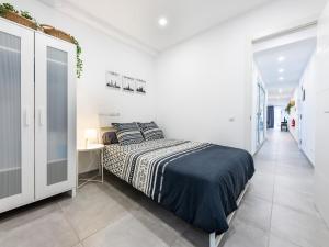 a white bedroom with a bed and a desk at House in Las Palmas near Playa de Las Canteras in Las Palmas de Gran Canaria
