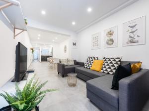 a living room with two couches and a tv at House in Las Palmas near Playa de Las Canteras in Las Palmas de Gran Canaria