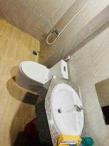 a bathroom with a white toilet in a room at Đức Trâm Hotel Hồ Chí Minh in Ho Chi Minh City