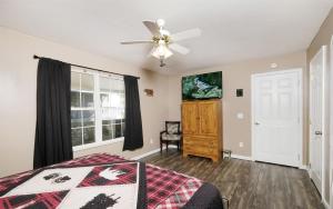 a bedroom with a bed and a ceiling fan at Peace at the River in Pigeon Forge