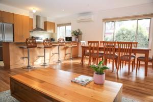 a kitchen and dining room with a table and chairs at Shine Bright in Bright