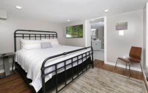 a bedroom with a large bed and a chair at Ogle Haven in Gatlinburg +37 photos