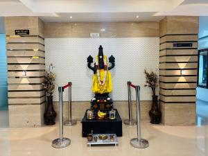 a room with a statue of a superhero on the wall at Hotel Lotus Grand Jubilee in Hyderabad