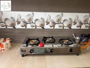 a kitchen stove with four bowls of food on it at DP Homestay Itanagar in Itānagar