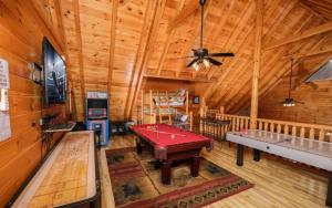 a room with a pool table in a cabin at Bearfoot Memories - Large Game Room, Outdoor Hot Tub + Community Pool Access in Henderson Springs