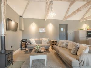 a living room with a couch and a table at Church Rooms in Northrepps
