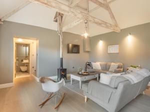 a living room with a couch and a fireplace at Church Rooms in Northrepps
