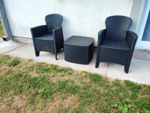 three wicker chairs and a table on a porch at Studio Apartman Oaza Nevesinje in Šehovina