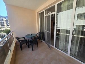 a balcony with a table and chairs in a apartment at Студиa Блу минута от плажа in Pomorie +4 photos