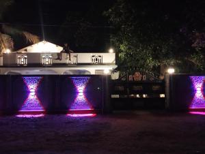 a house lit up with purple lights at night at Cha Cha Guest in Trincomalee