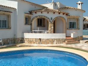 a villa with a swimming pool in front of a house at Villas Los Olivares - Deniasol in Els Poblets
