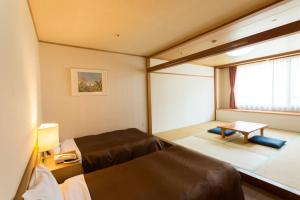 Postel nebo postele na pokoji v ubytování Washigatake Kogen Hotel Rainbow + 19 fotografií