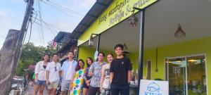 a group of people standing in front of a building at King seafood koh kood in Ban Khlong Mat