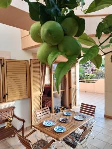 a wooden table with plates of food under a plant at Deluxe garden flat near Terra-Mítica in Benidorm