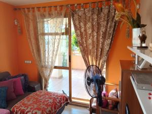a room with a door with a fan and a window at Deluxe garden flat near Terra-Mítica in Benidorm