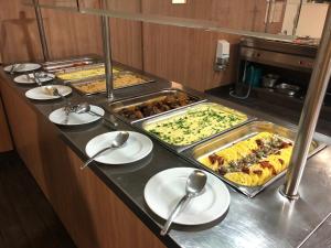 a buffet line with many different types of food at Castellum Apartmanház in Gyula