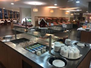 a buffet line in a restaurant with food at Castellum Apartmanház in Gyula
