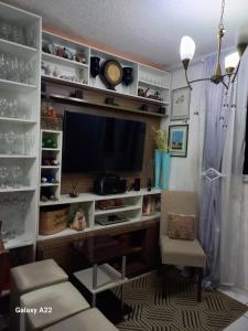 a home office with a desk and a tv at apartamento cop30 in Ananindeua