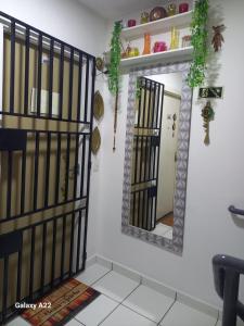 a room with a mirror and a white wall at apartamento cop30 in Ananindeua